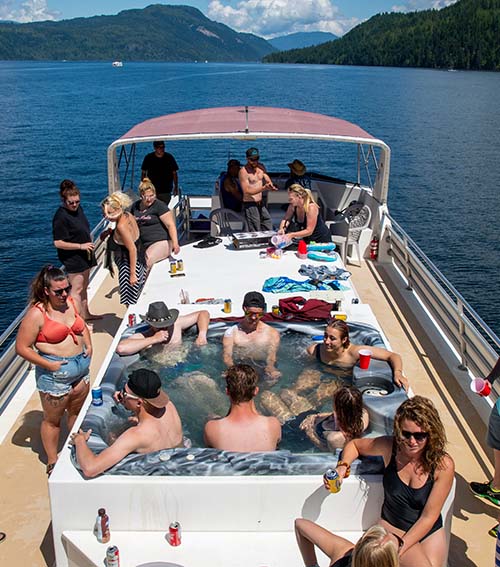 A picutre our staff enjoying a warm summer day on the top deck of a houseboat.