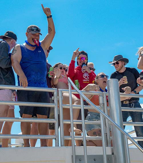 A picutre our staff enjoying a warm summer day on the top deck of a houseboat.