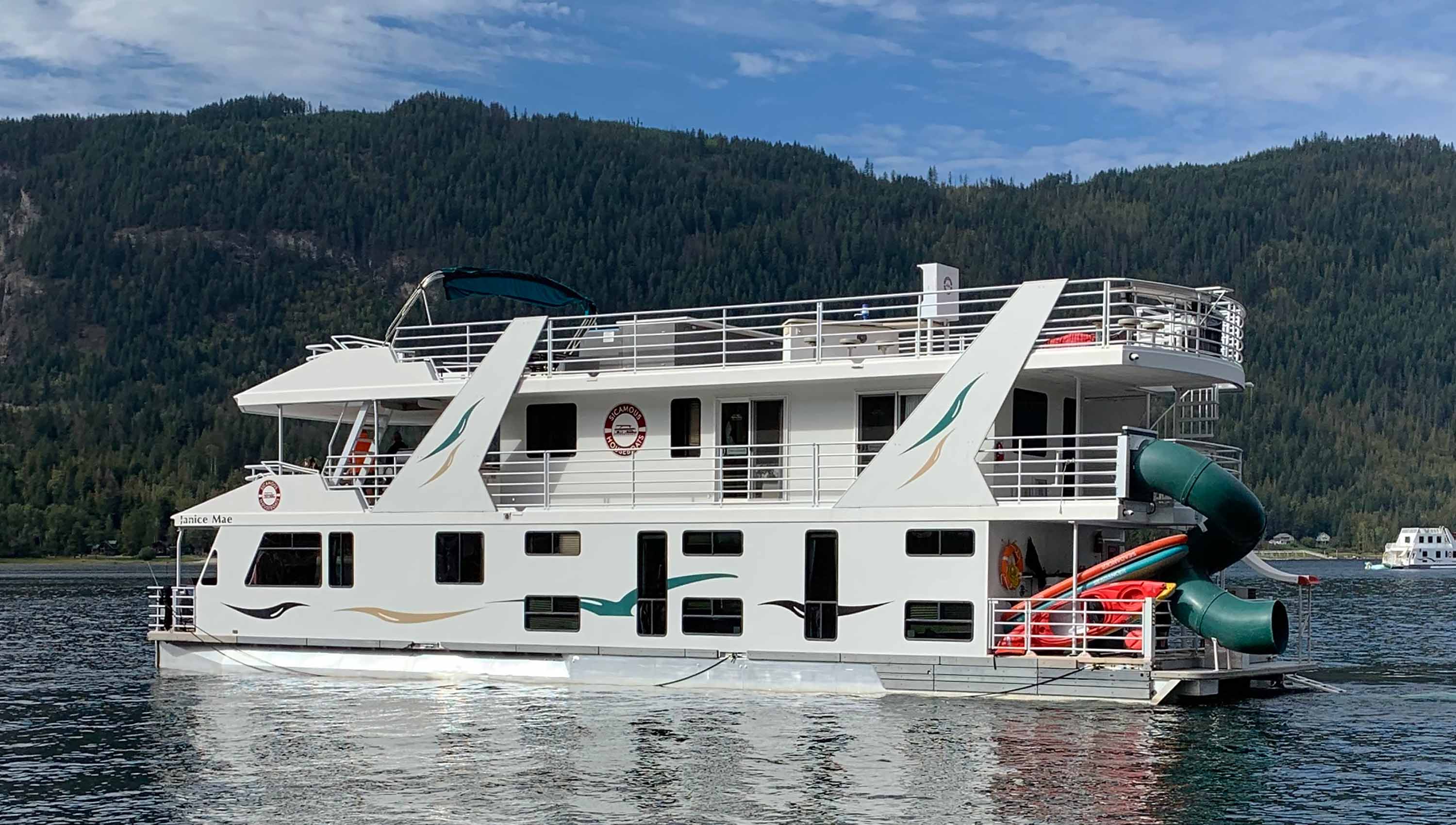 The CruiseCraft sailing on Shuswap lake on a calm, sunny day.